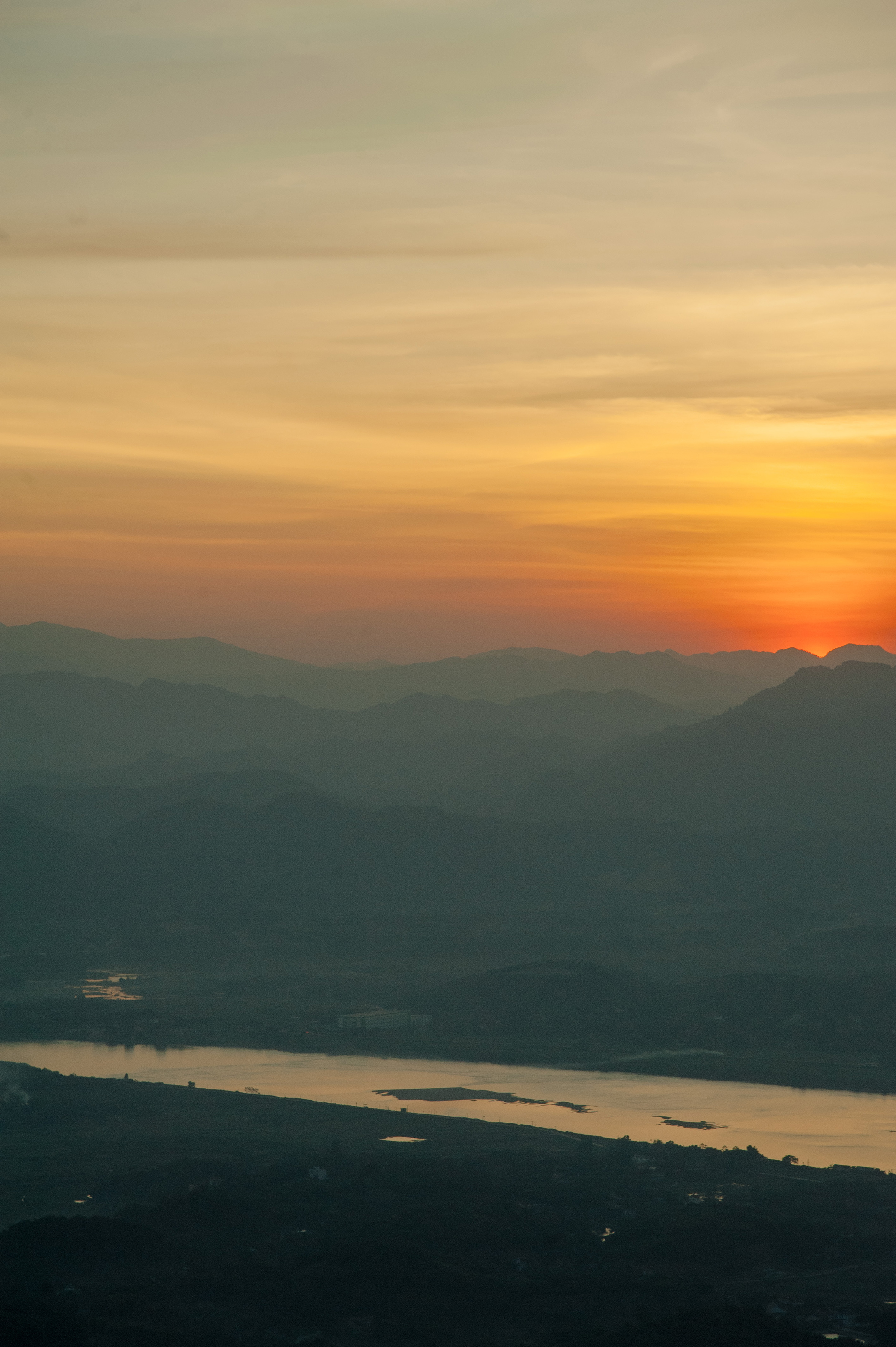 a sunset over a mountain range