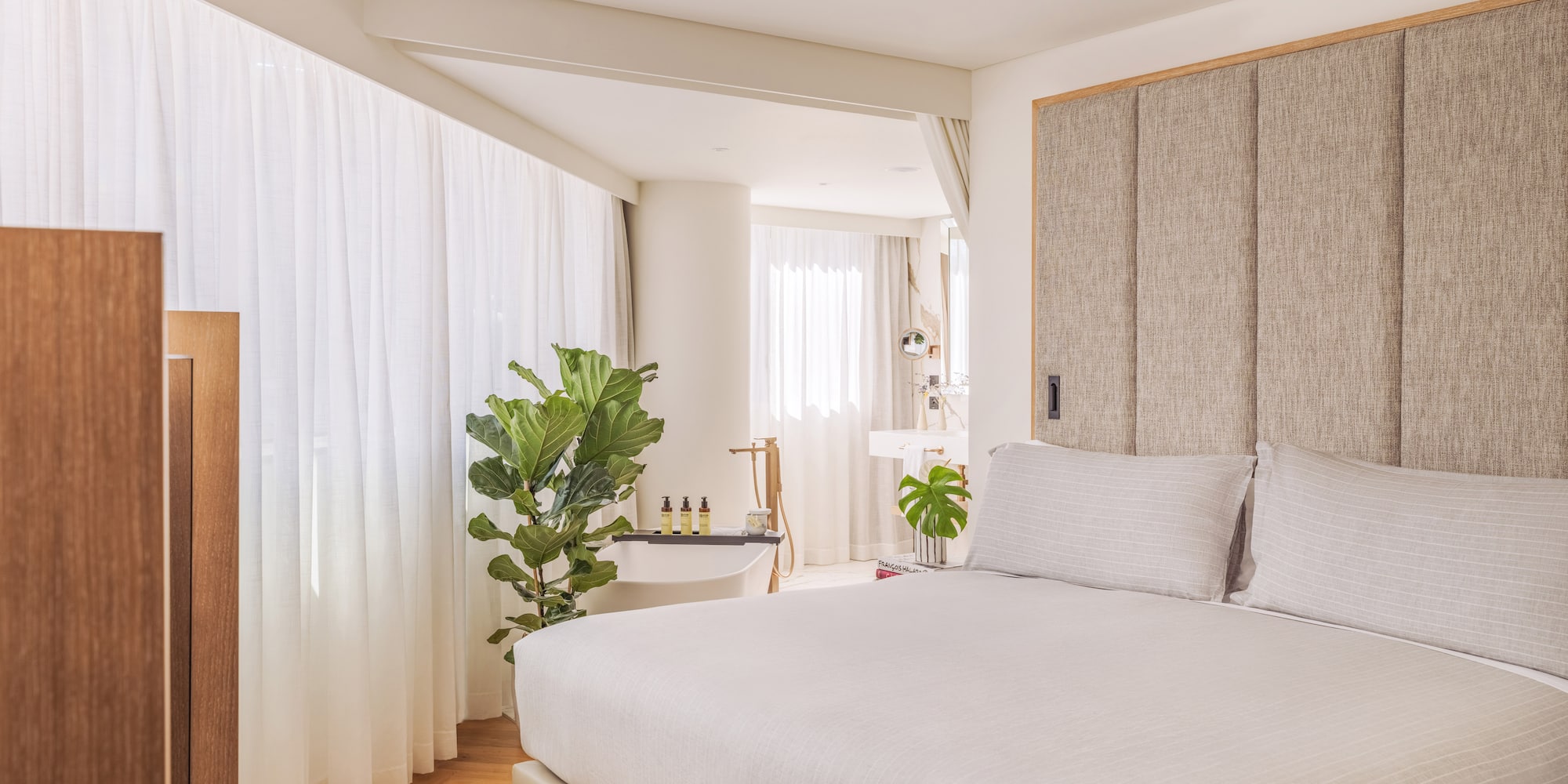 a bedroom with a bed and a sink and a plant