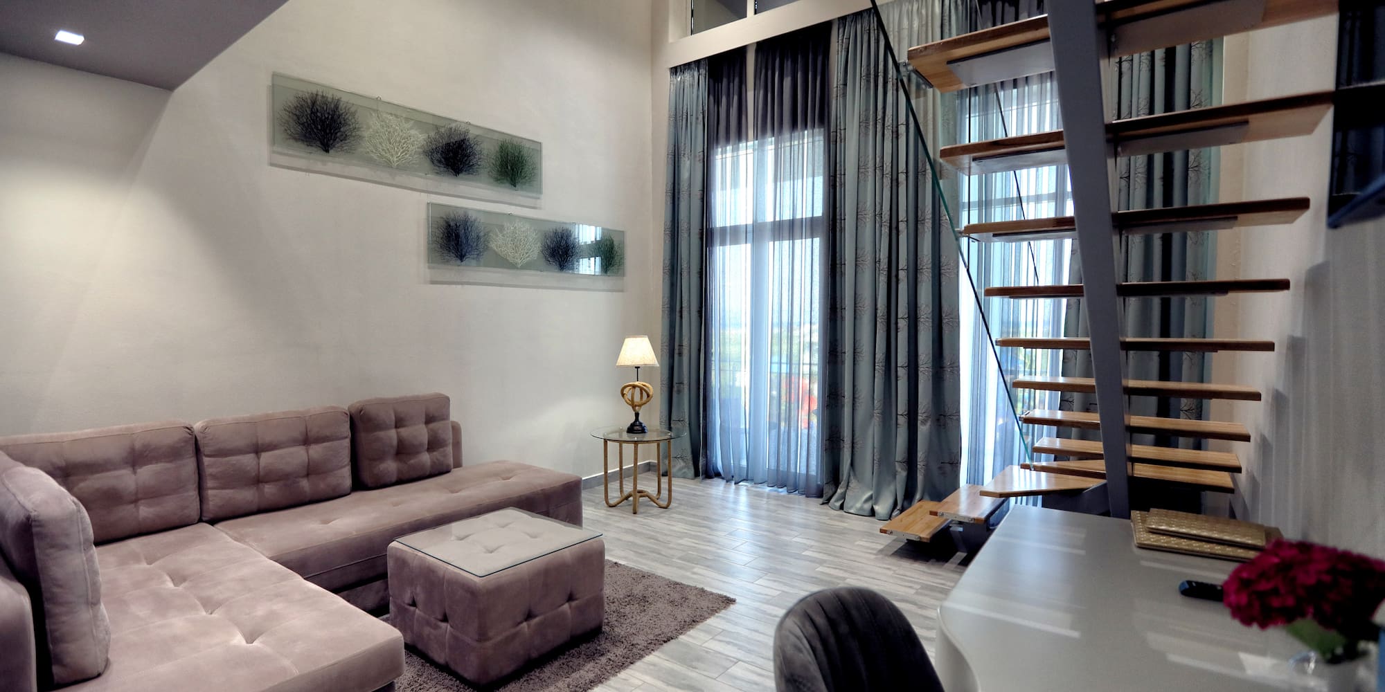 a living room with a staircase and couch