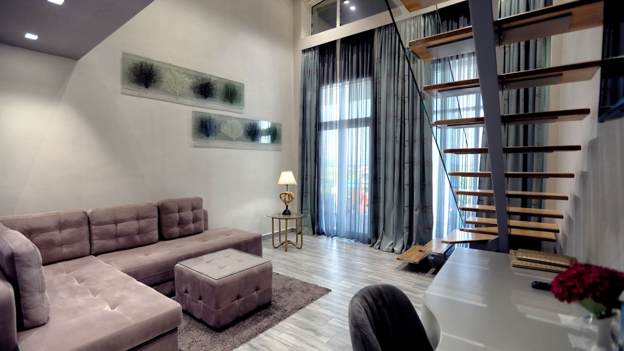 a living room with a staircase and couch