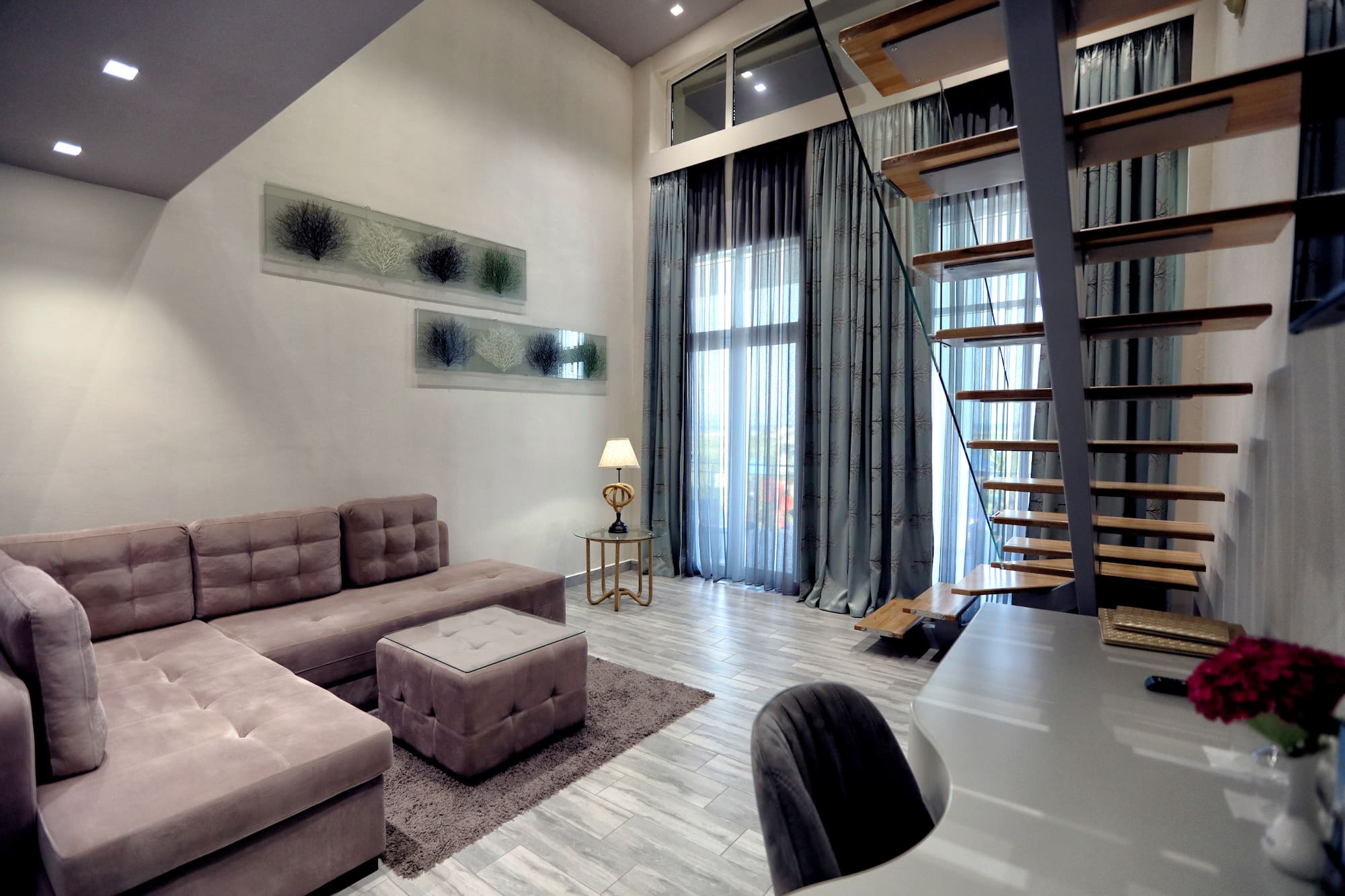 a living room with a staircase and couch