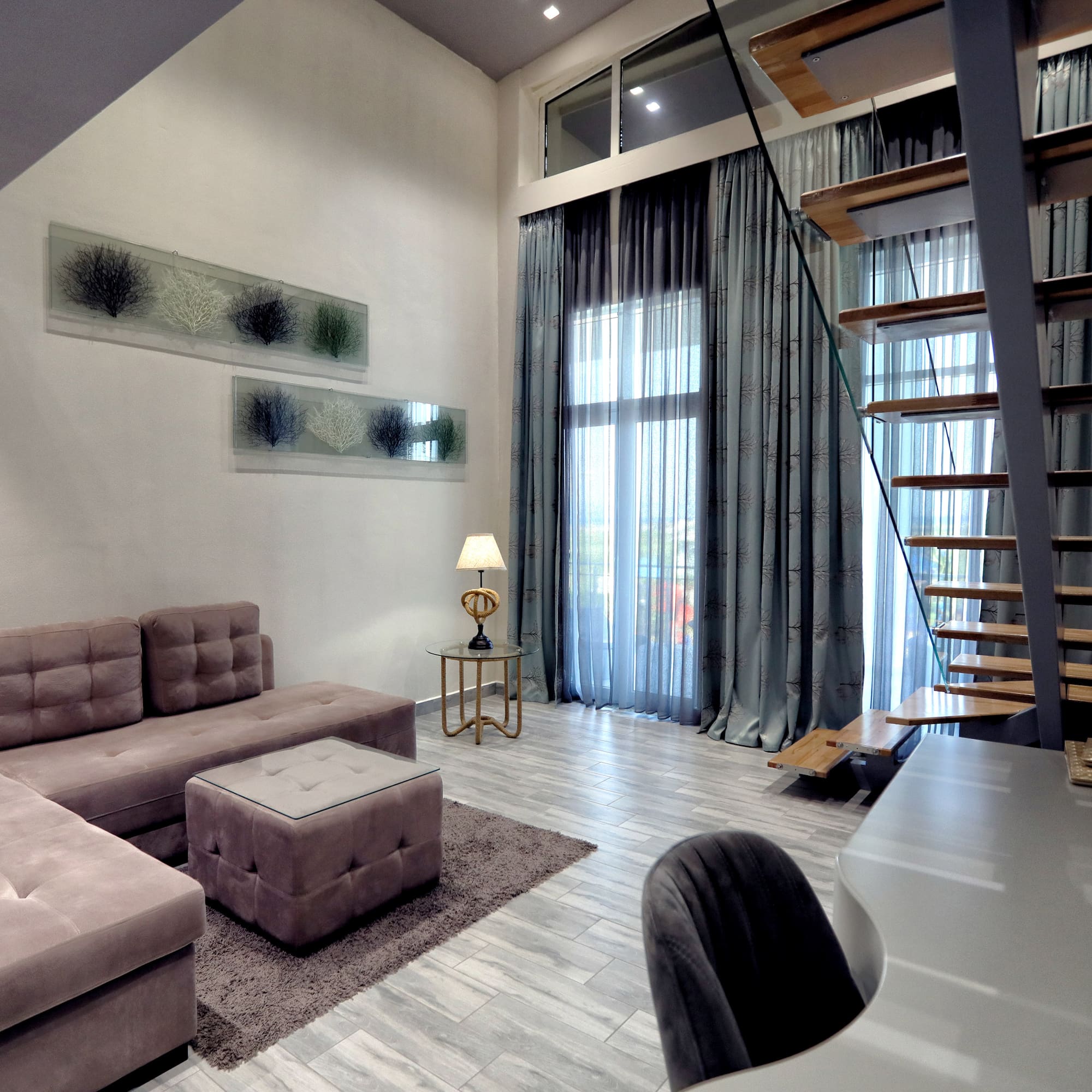 a living room with a staircase and couch