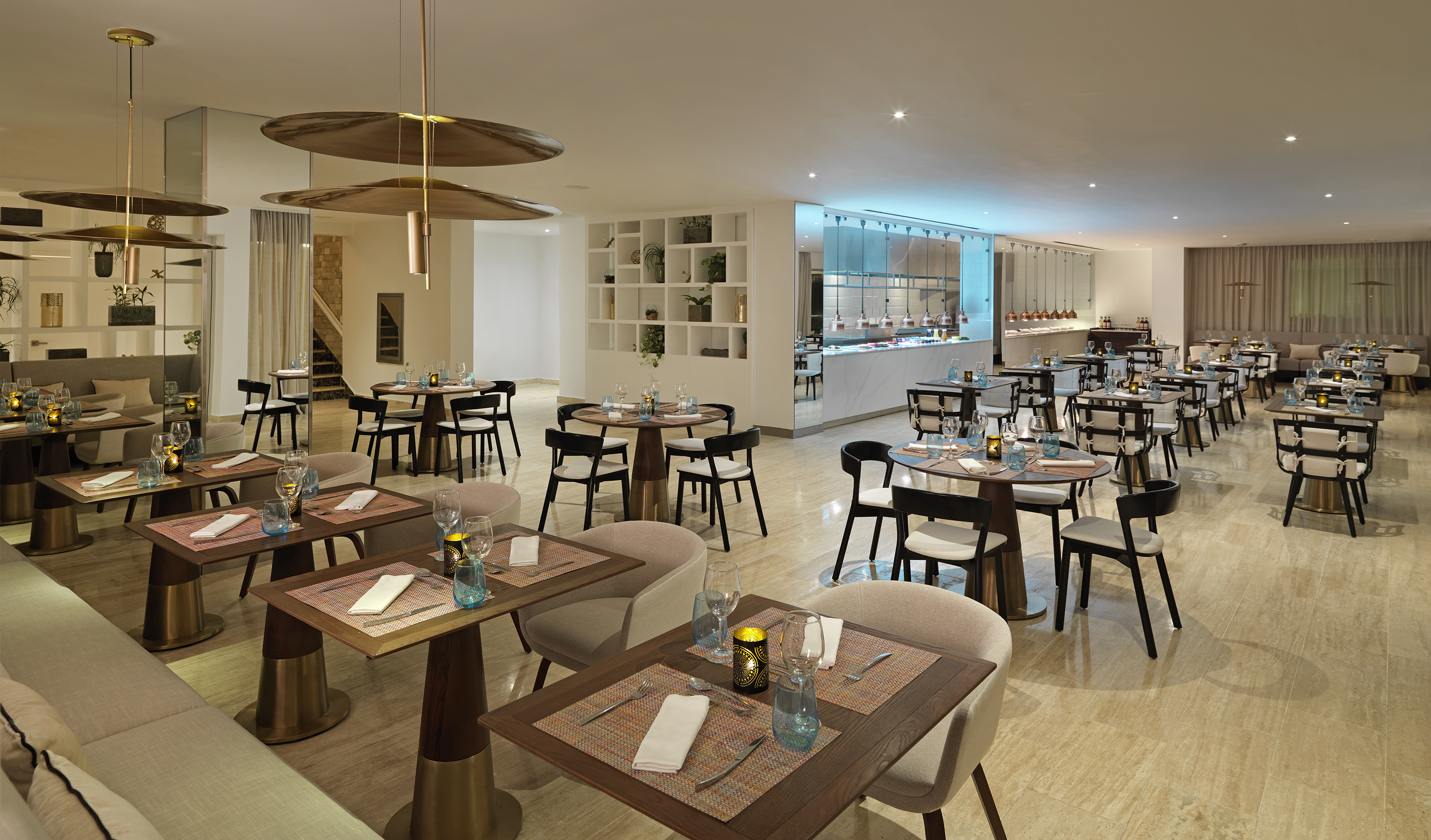 Modern upscale restaurant dining room with set tables and a sleek buffet.