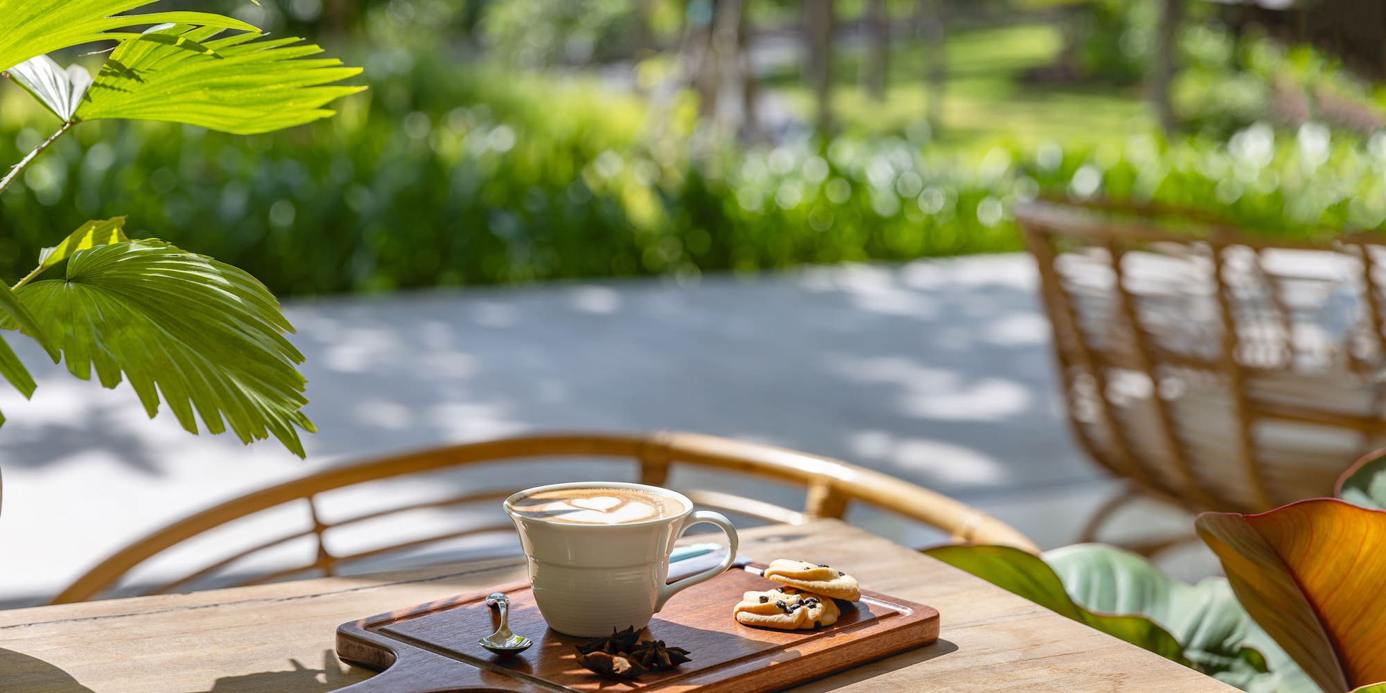 a cup of coffee and cookies on a wooden tray