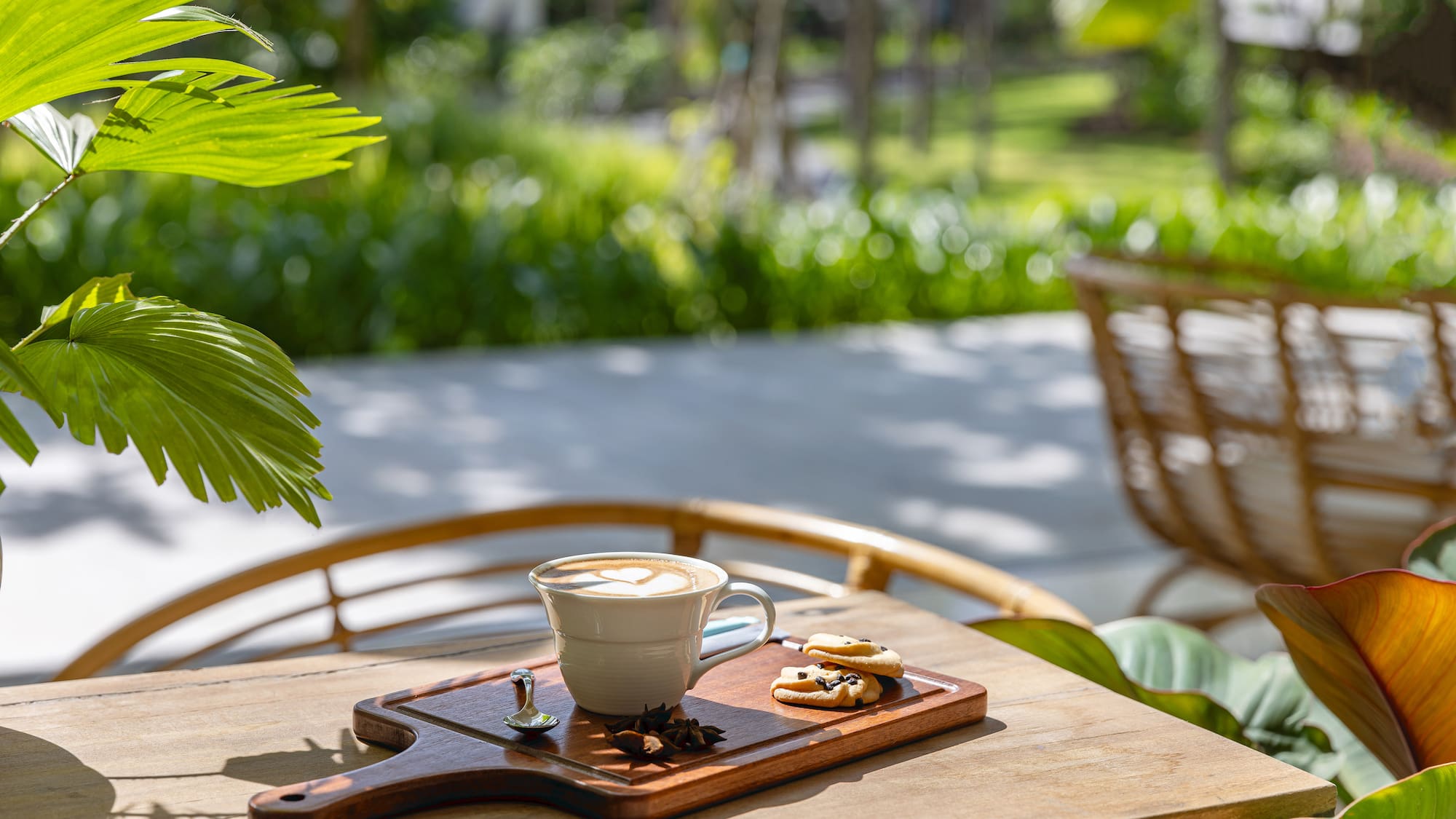 a cup of coffee and cookies on a wooden tray