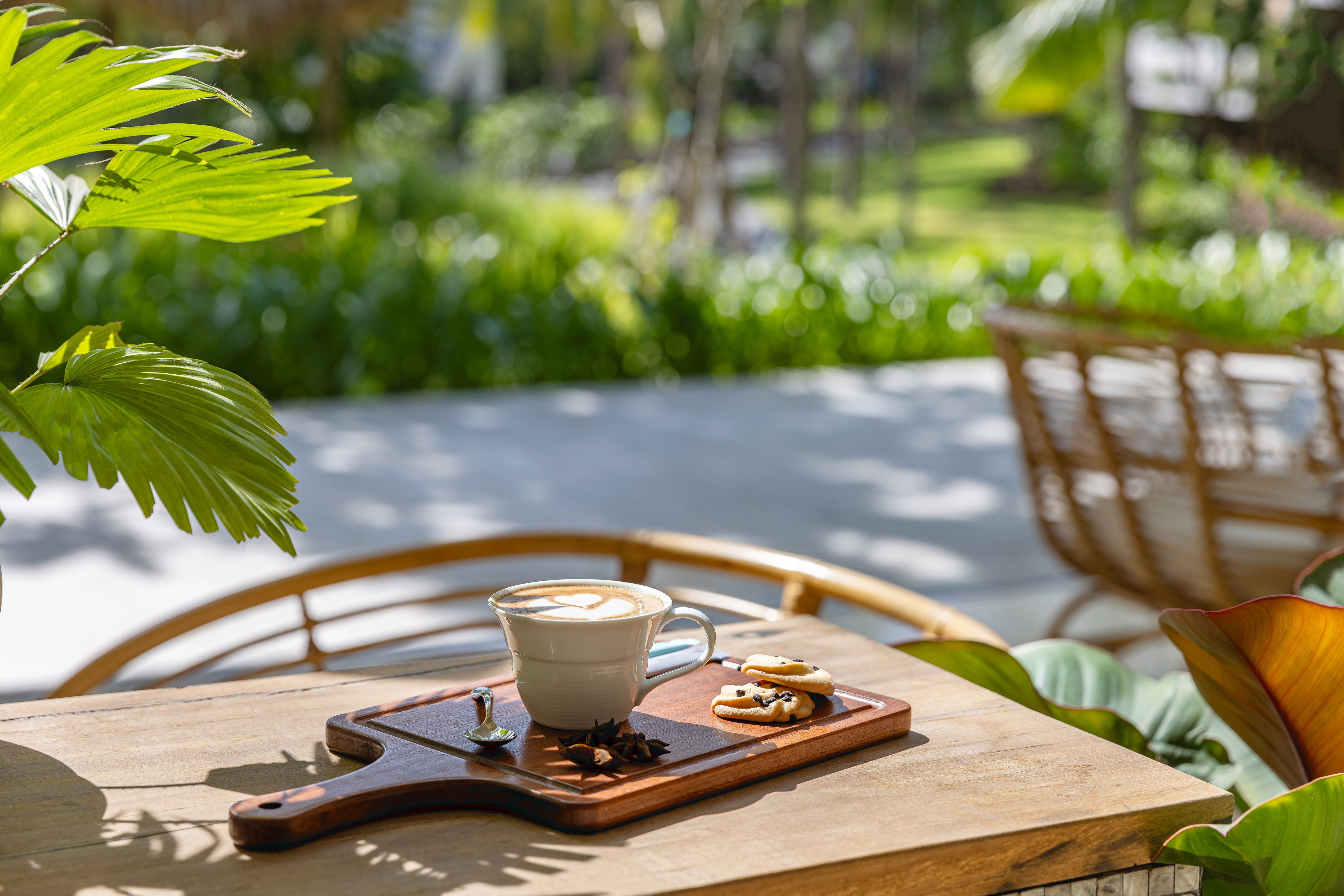 a cup of coffee and cookies on a wooden tray