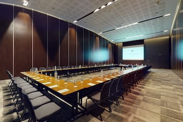 a long conference room with a large table and chairs