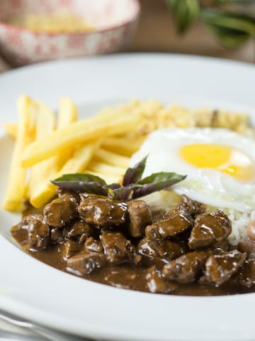 a plate of food with a fried egg and rice