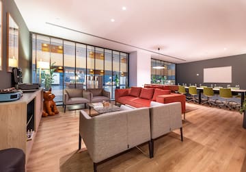 a room with a couch and chairs