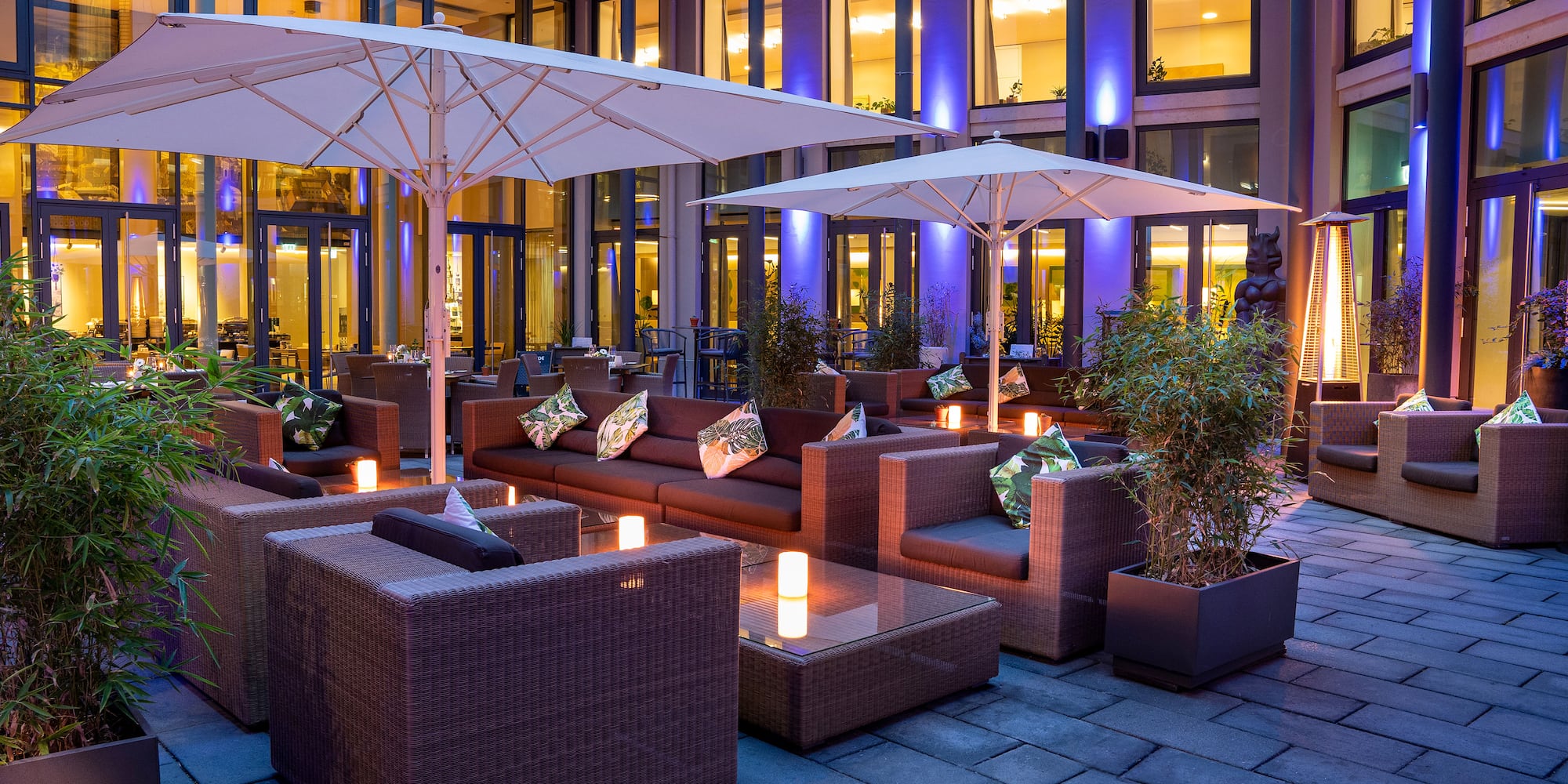 a patio area with chairs and umbrellas