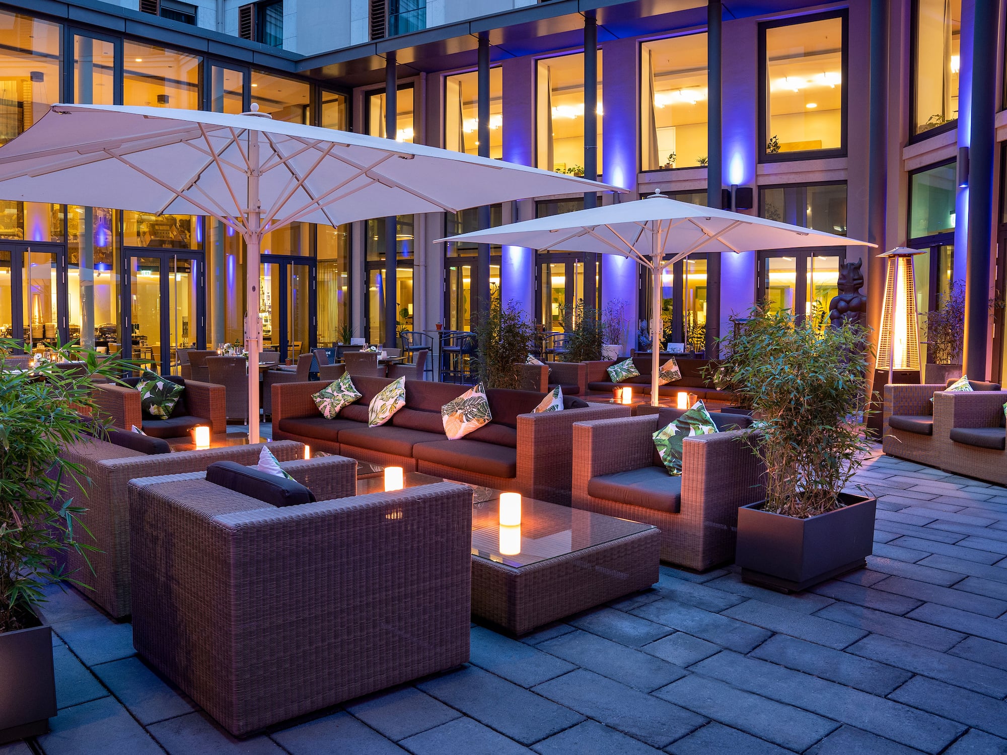a patio area with chairs and umbrellas