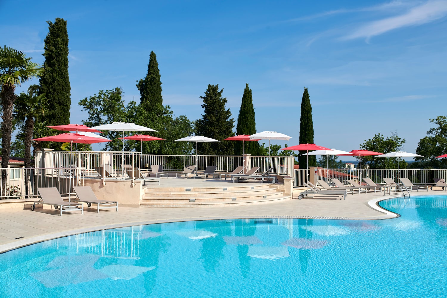 a pool with umbrellas and chairs