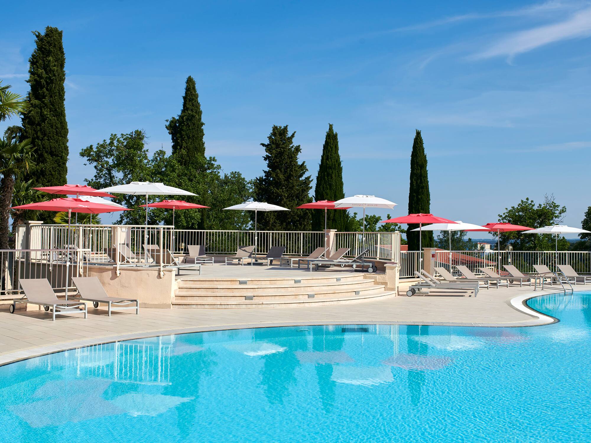 a pool with umbrellas and chairs