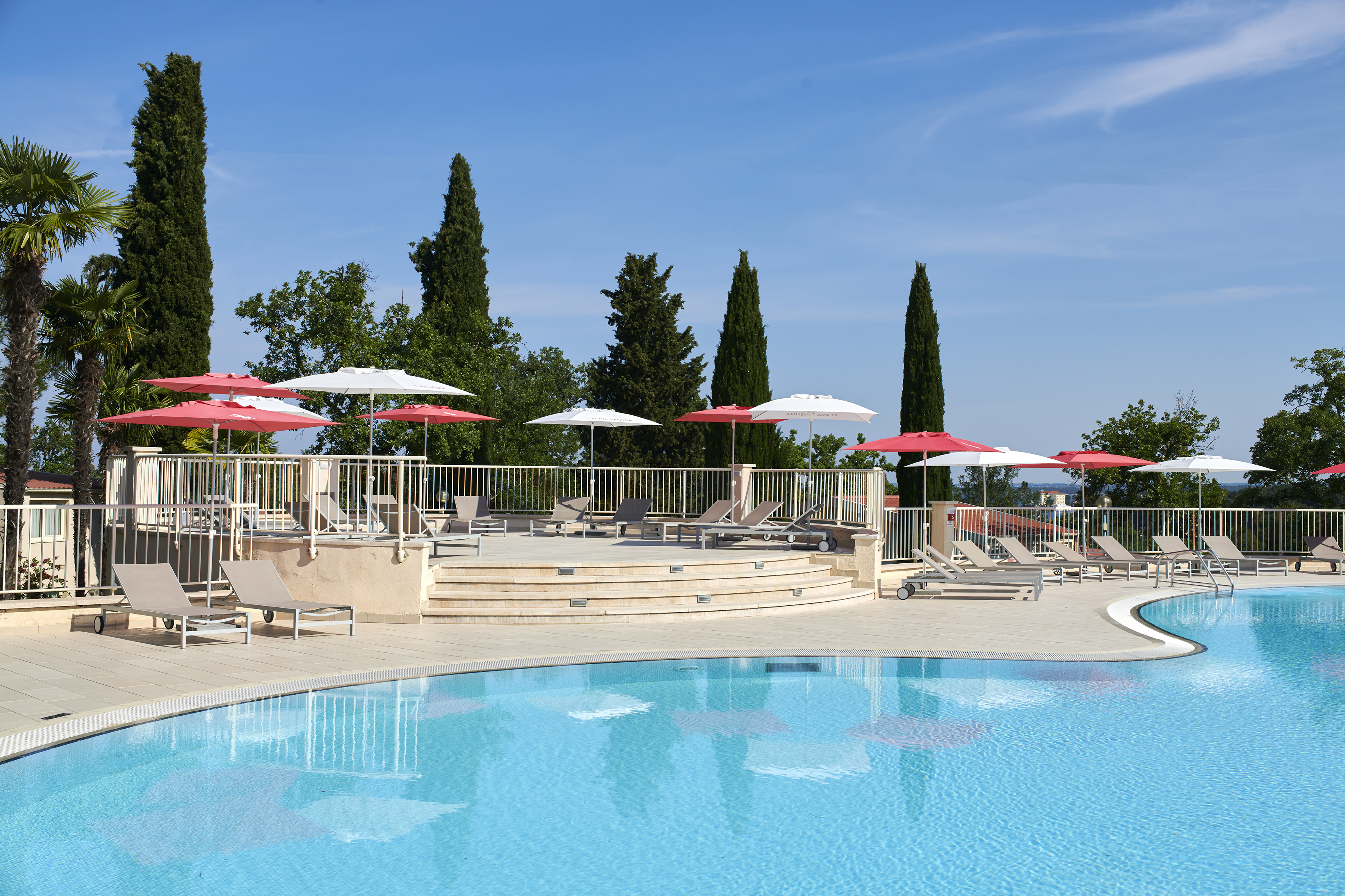 a pool with umbrellas and chairs