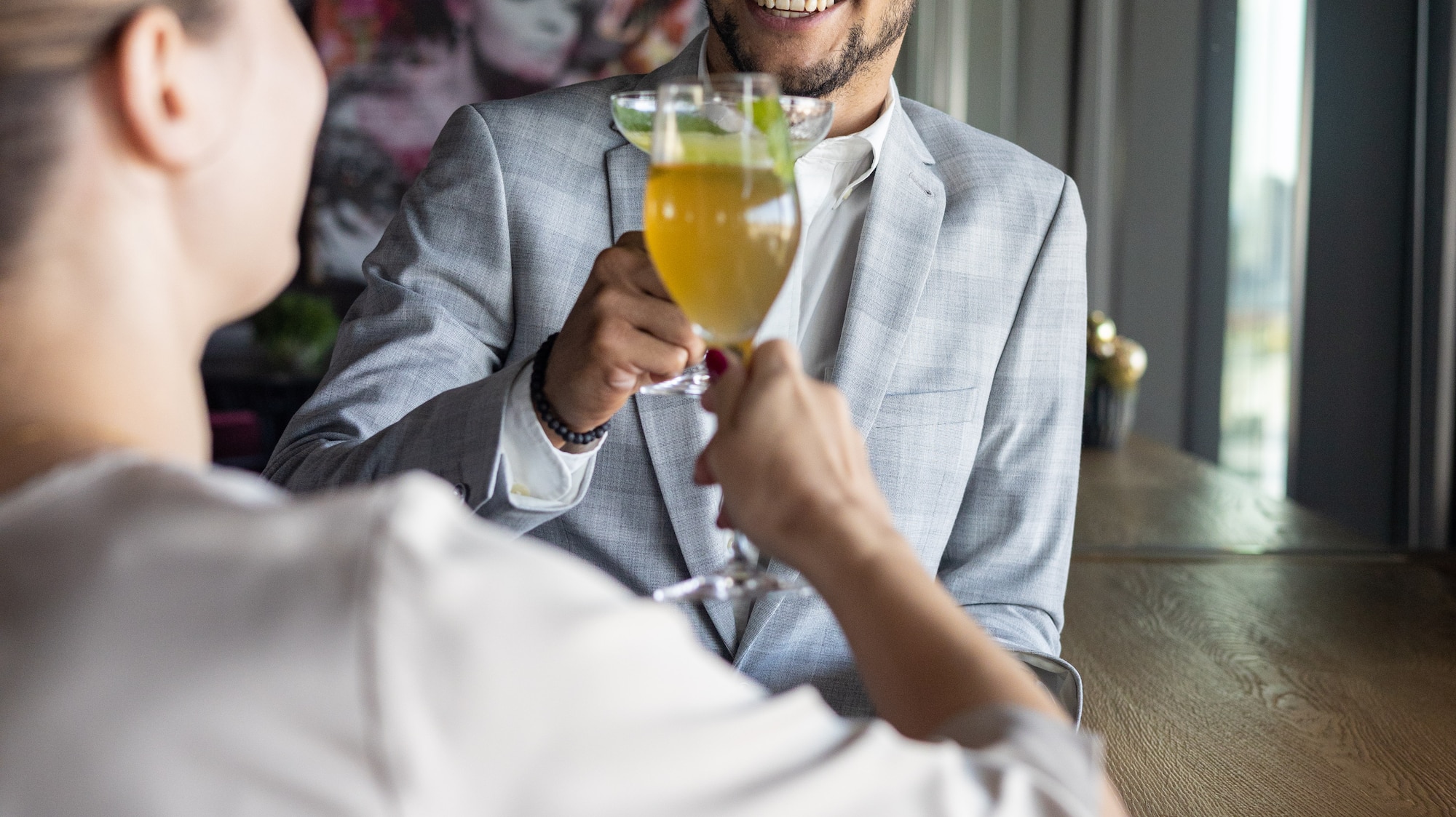 a man and woman holding drinks