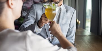 a man and woman holding drinks