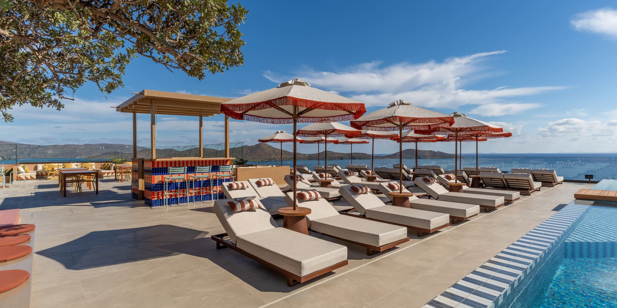 a pool with lounge chairs and umbrellas