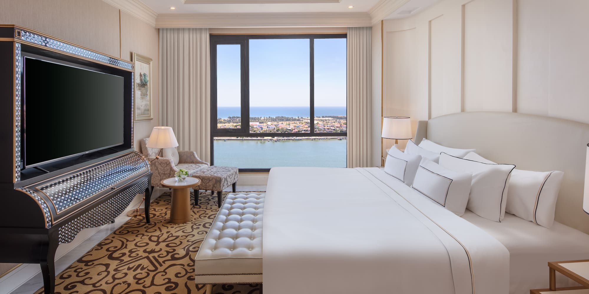 a room with a large bed and a television