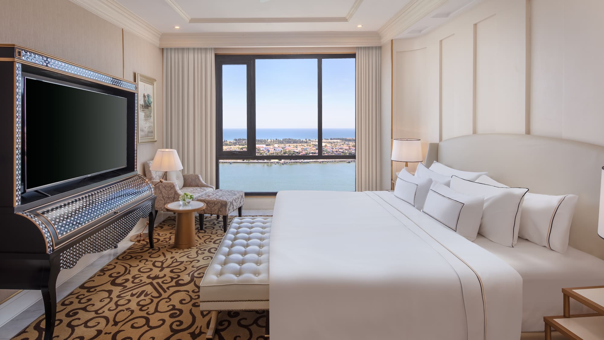 a room with a large bed and a television