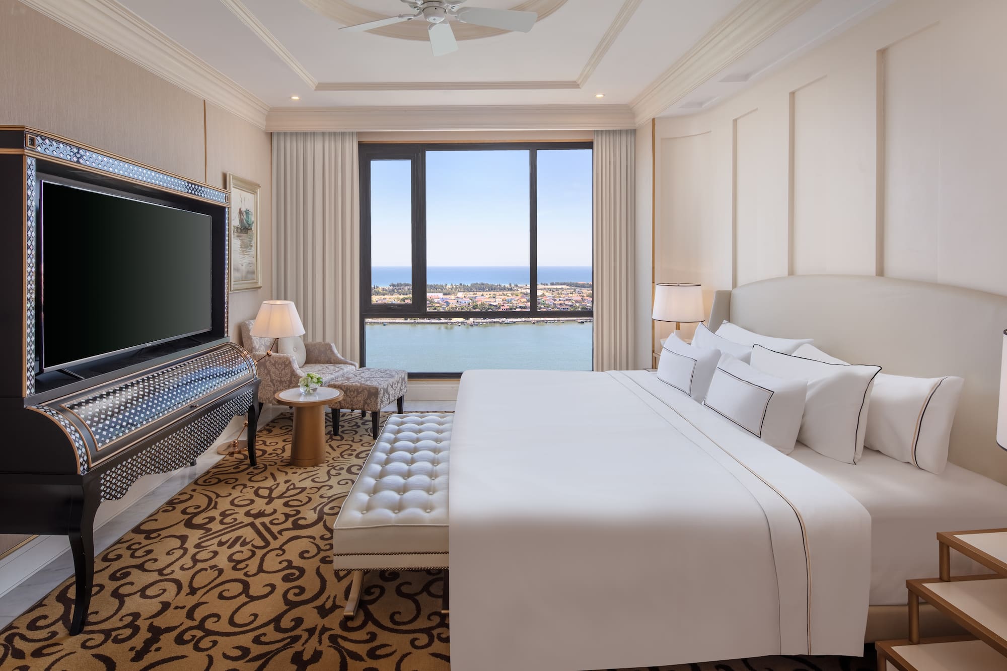 a room with a large bed and a television