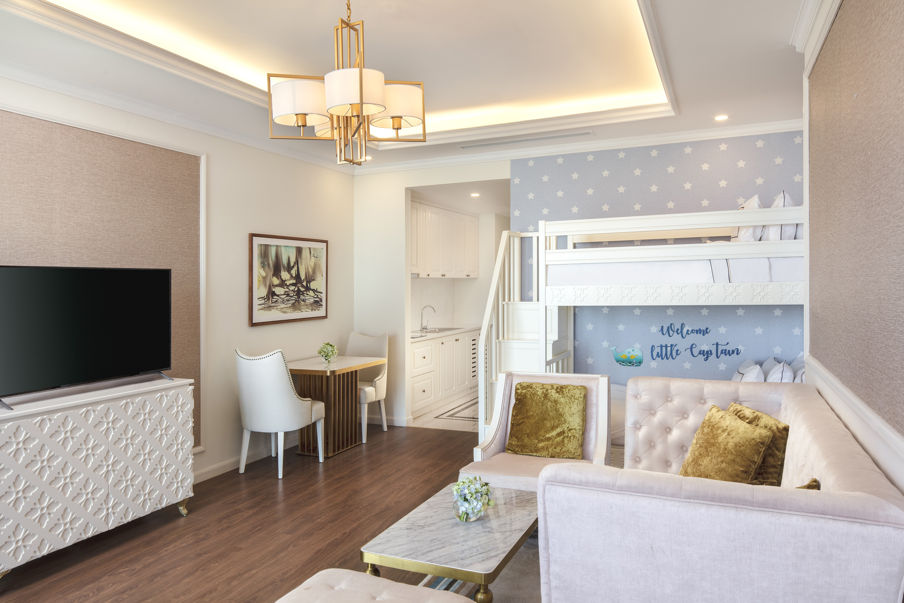 Luxury family suite with bunk beds, living area, and kitchenette.