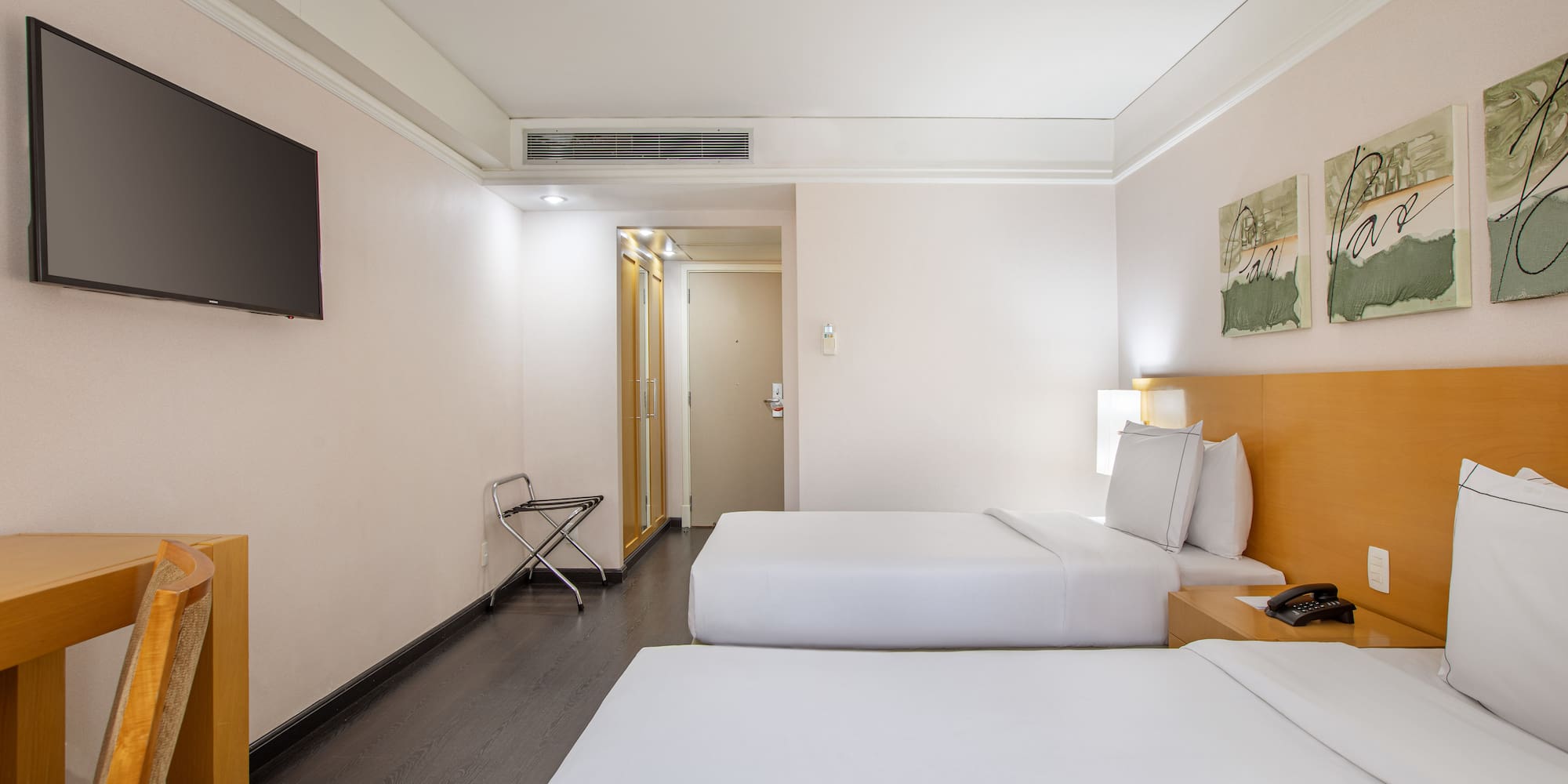 a room with two beds and a tv