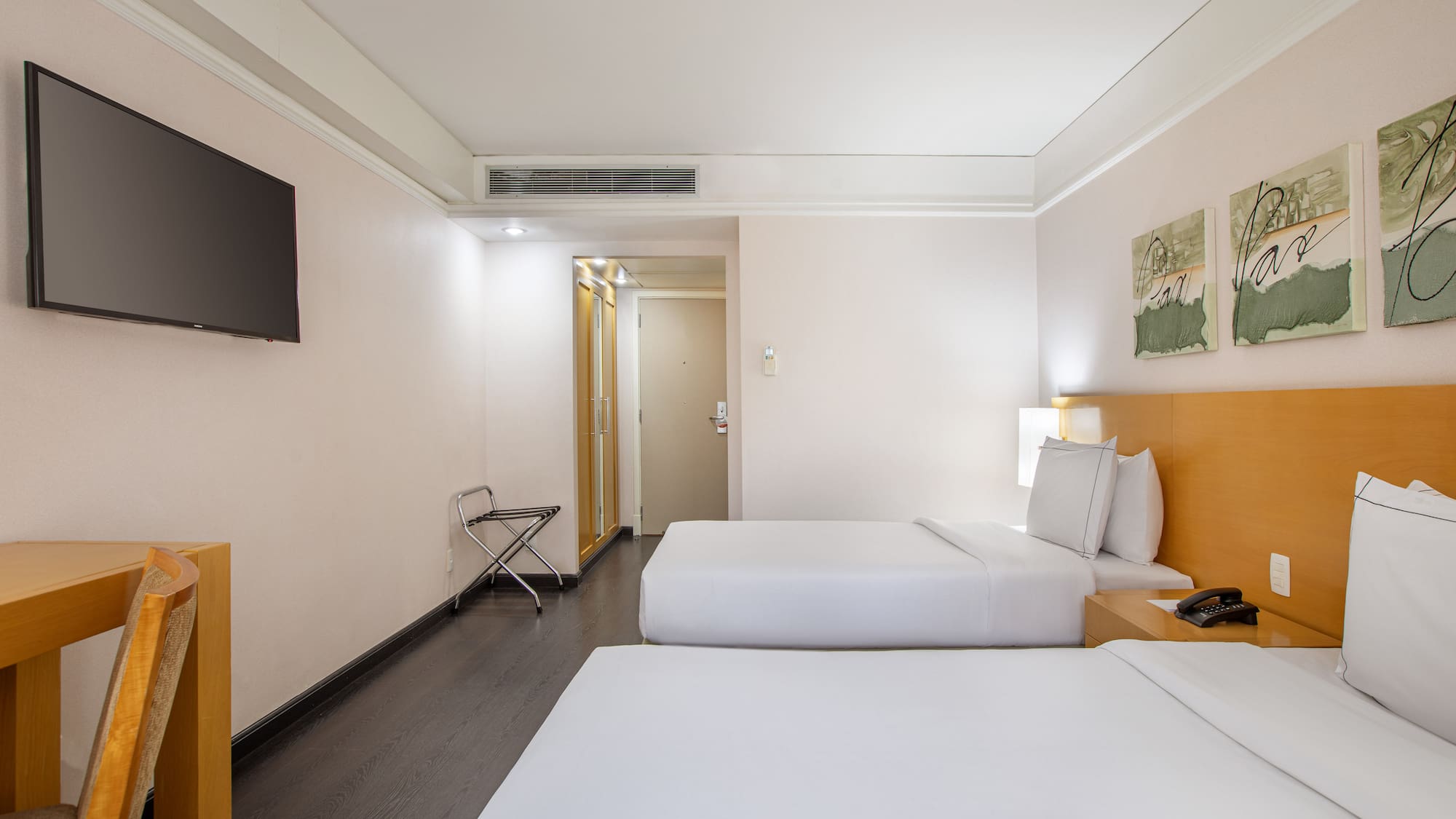 a room with two beds and a tv