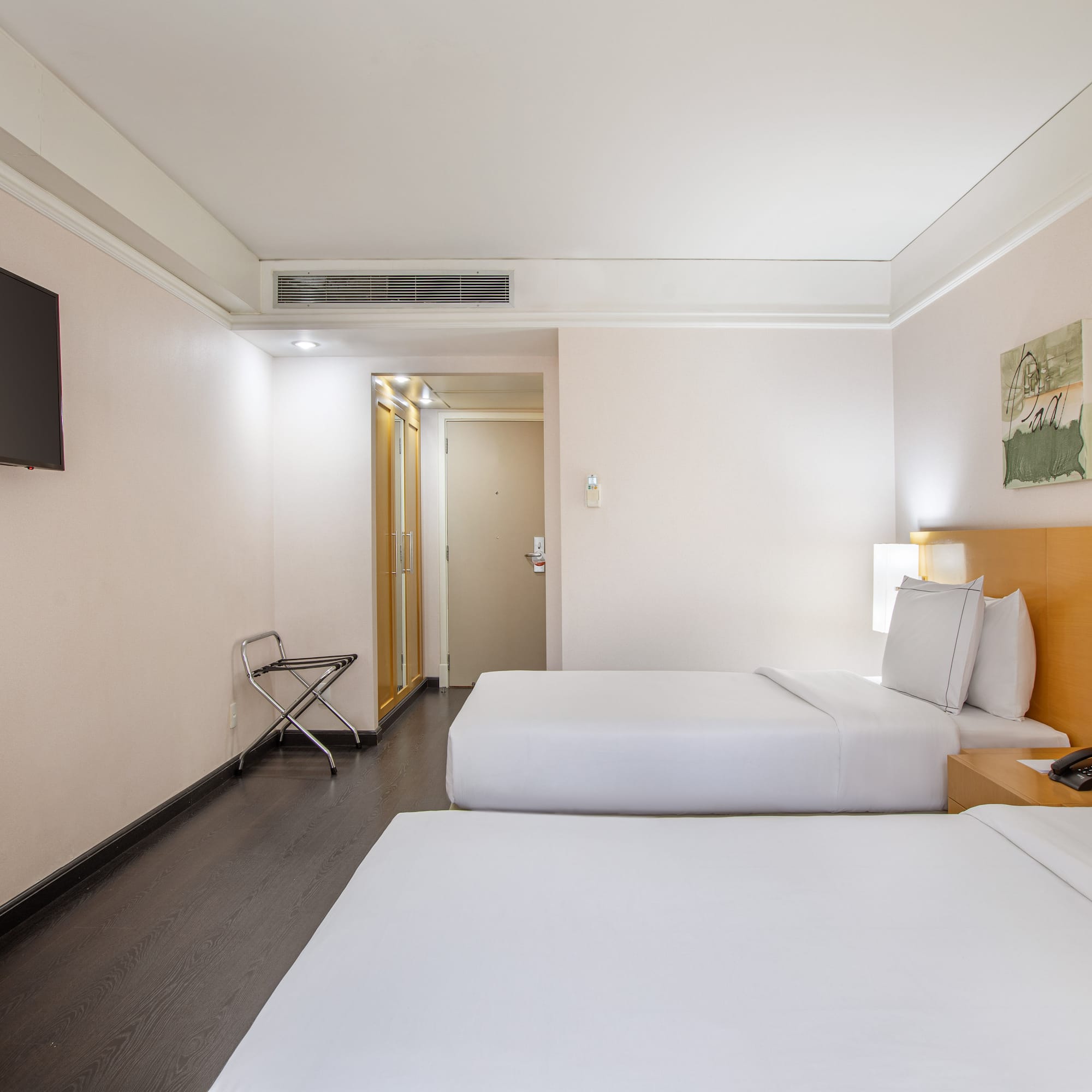 a room with two beds and a tv