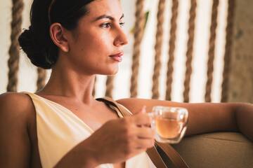 a woman holding a cup of tea