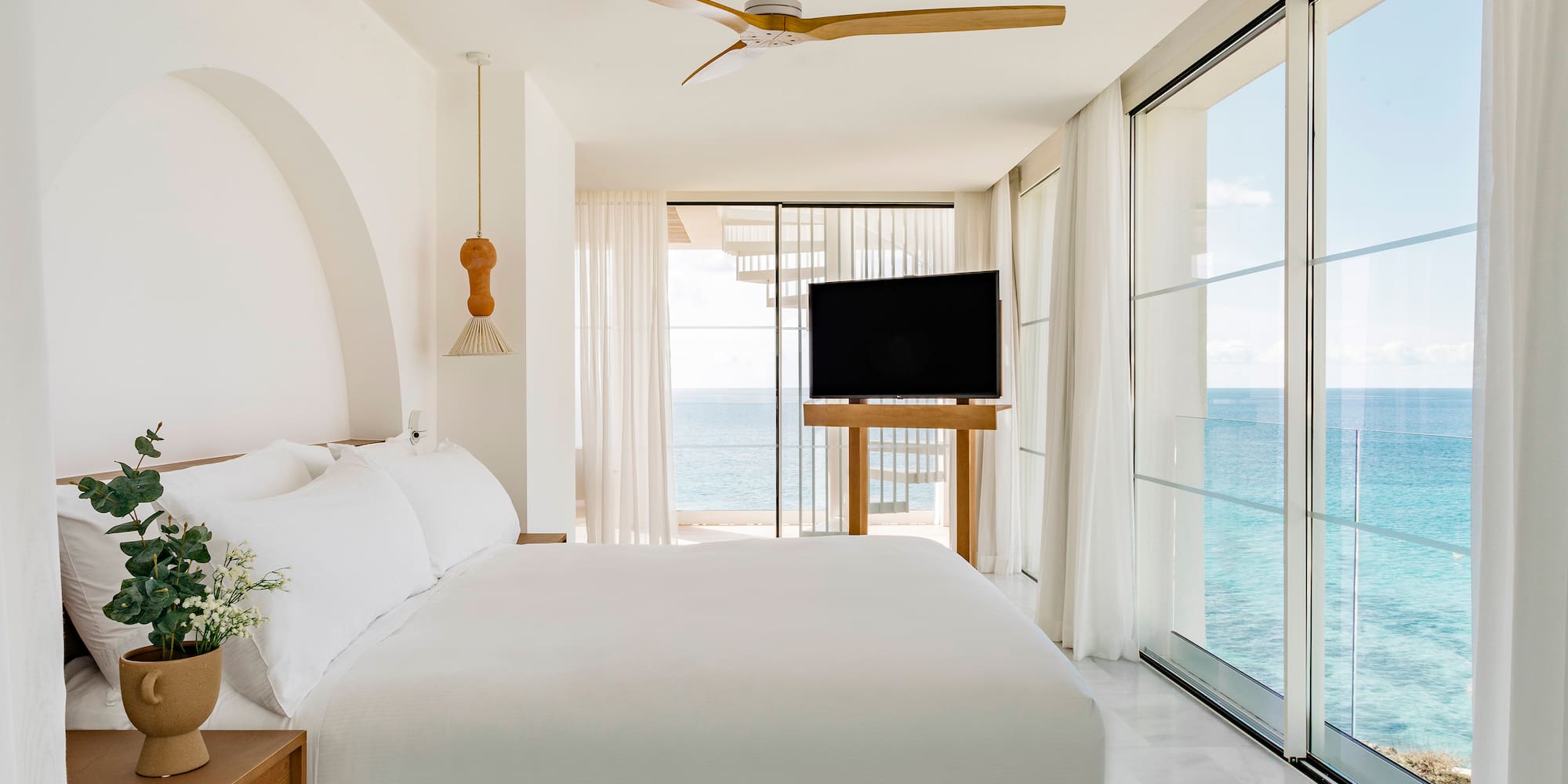 a bedroom with a large bed and a television