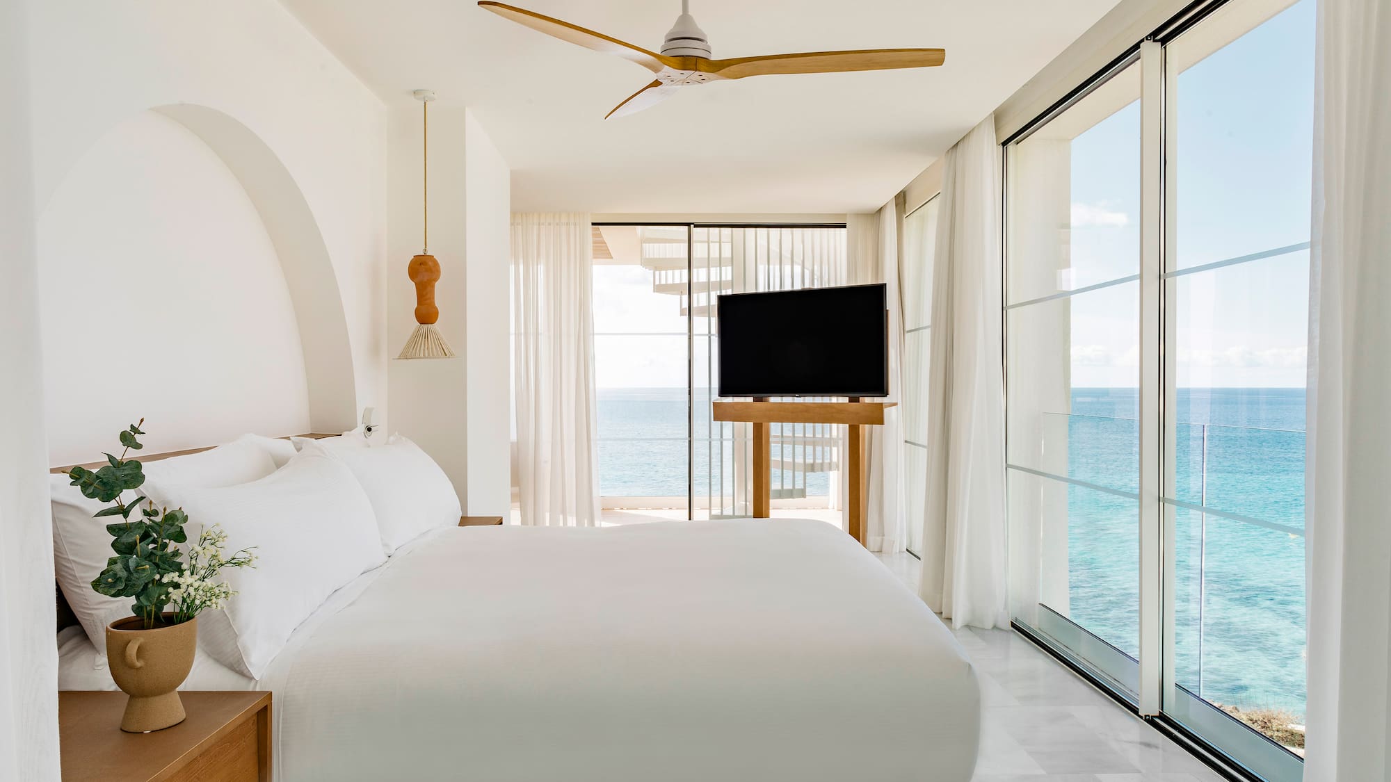 a bedroom with a large bed and a television