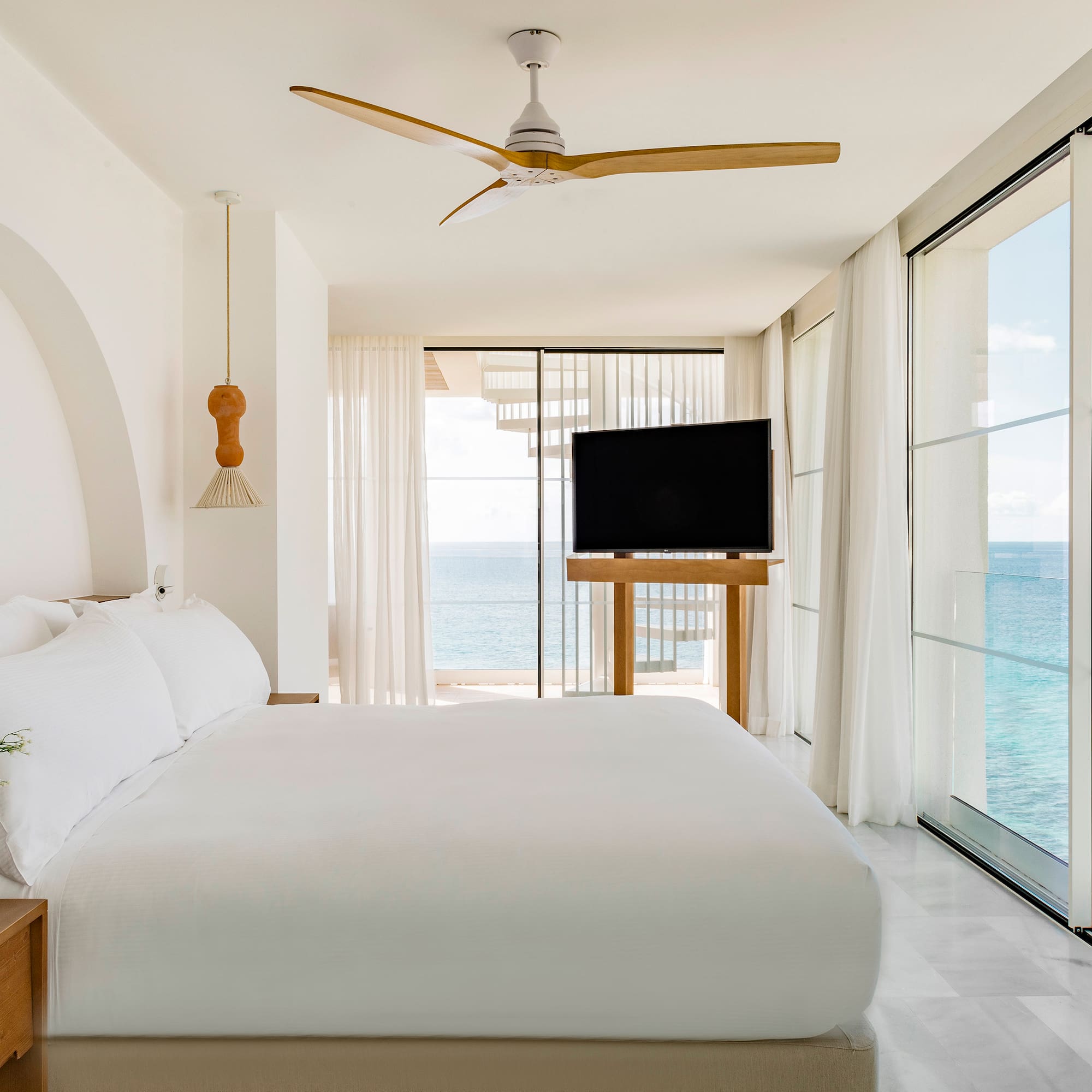 a bedroom with a large bed and a television