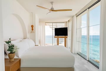 a bedroom with a large bed and a television
