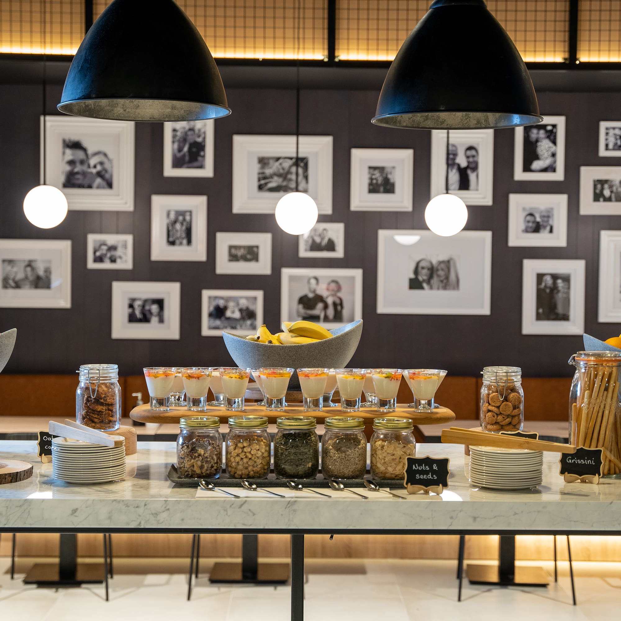 Hotel buffet with fresh fruit, yogurt parfaits, assorted cookies, and nuts.