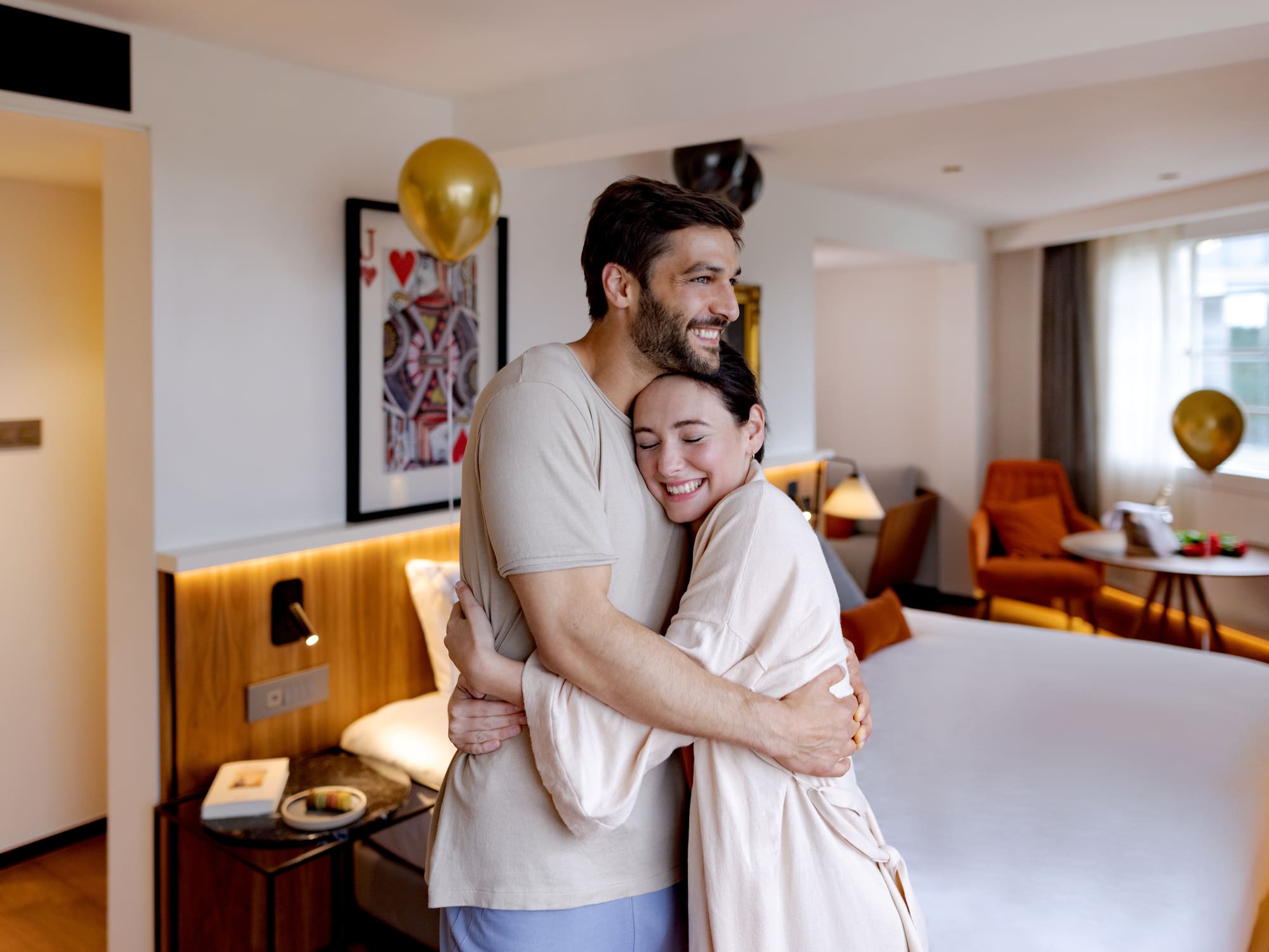 a man and woman hugging in a room