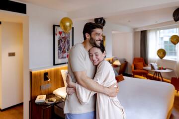 a man and woman hugging in a room