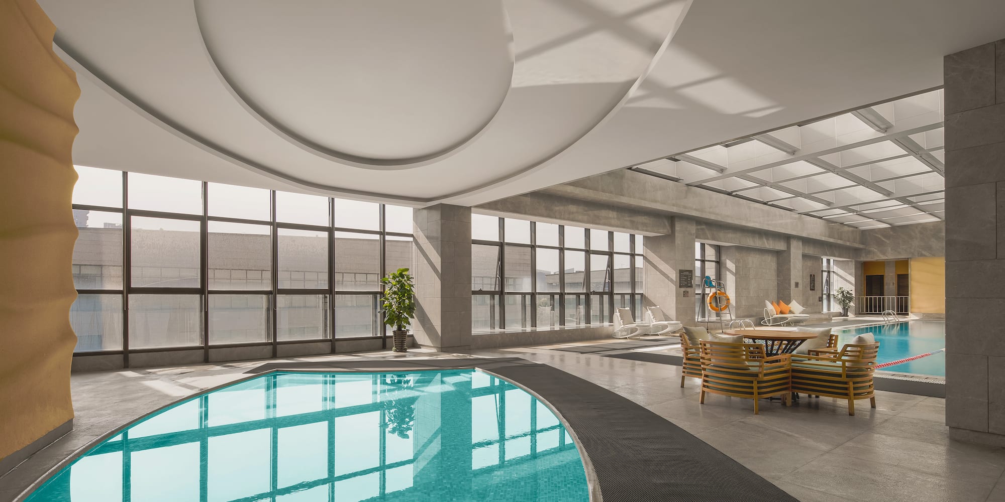 a pool in a room with windows