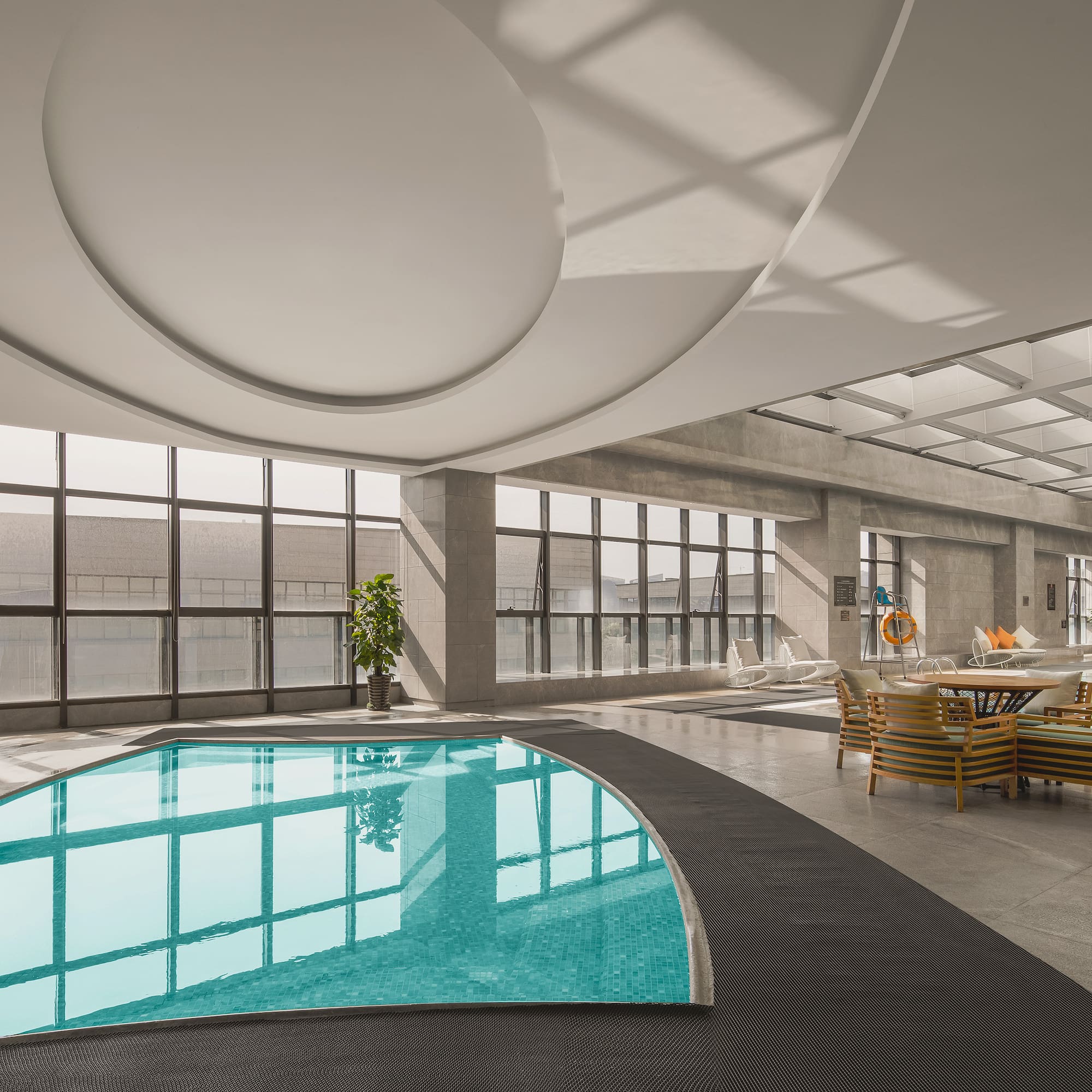 a pool in a room with windows