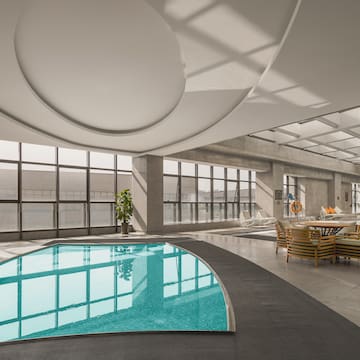 a pool in a room with windows