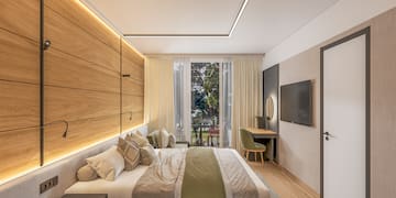 a bedroom with a bed and a television
