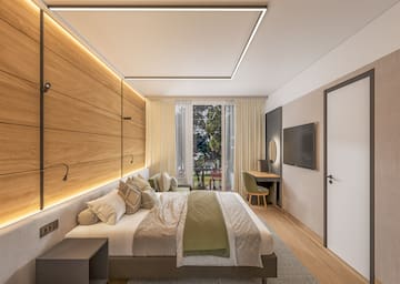 a bedroom with a bed and a television