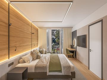 a bedroom with a bed and a television