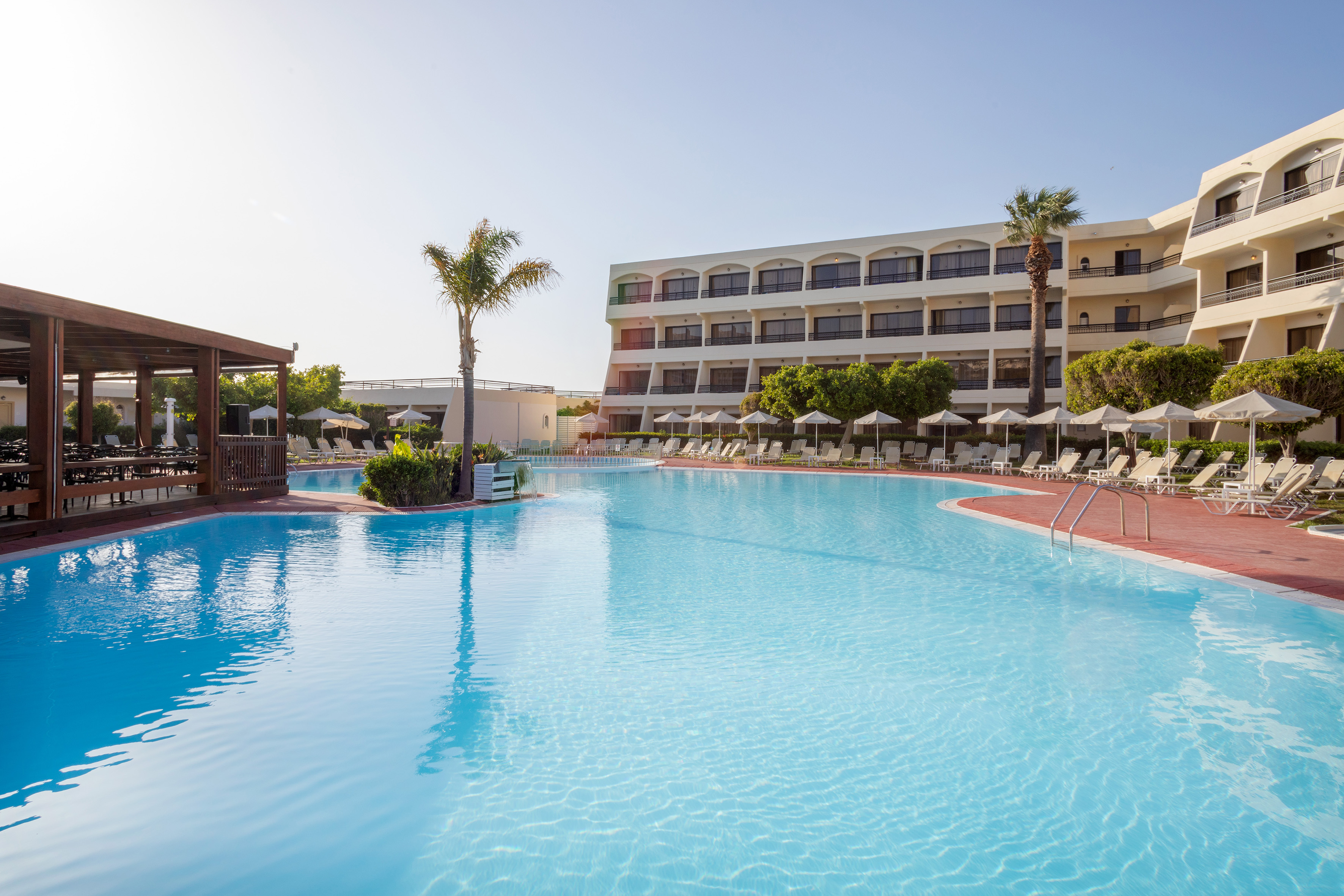 a swimming pool with a building in the background