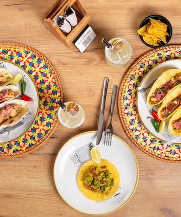 a group of plates with tacos on them