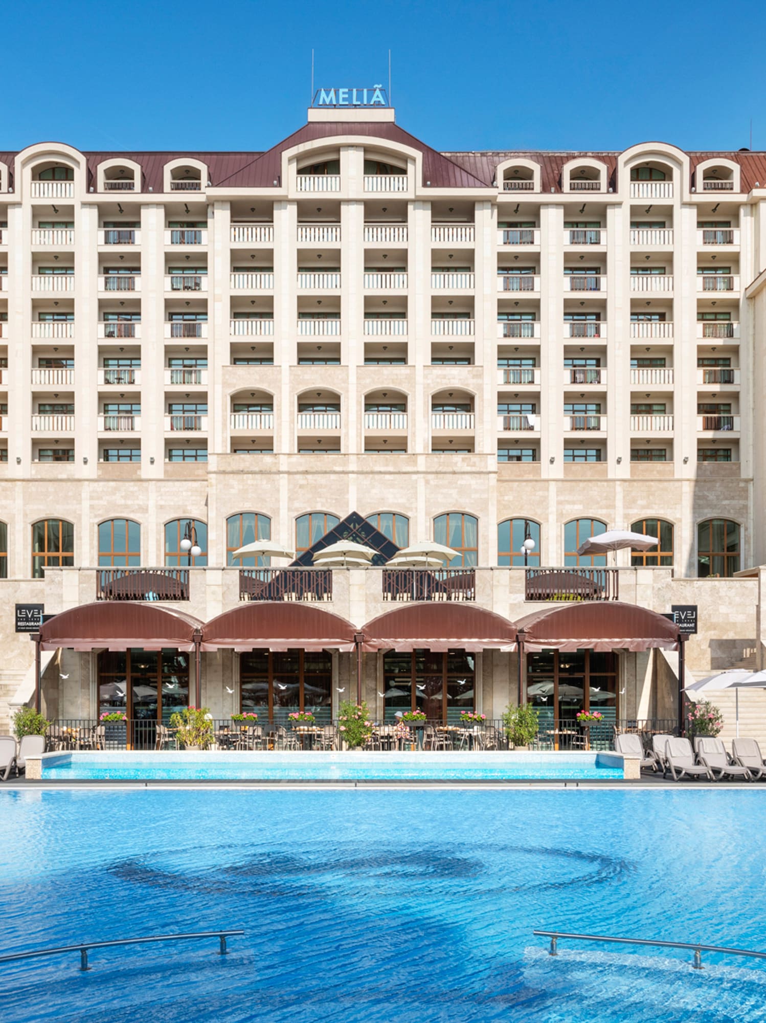 a large building with a pool in front of it