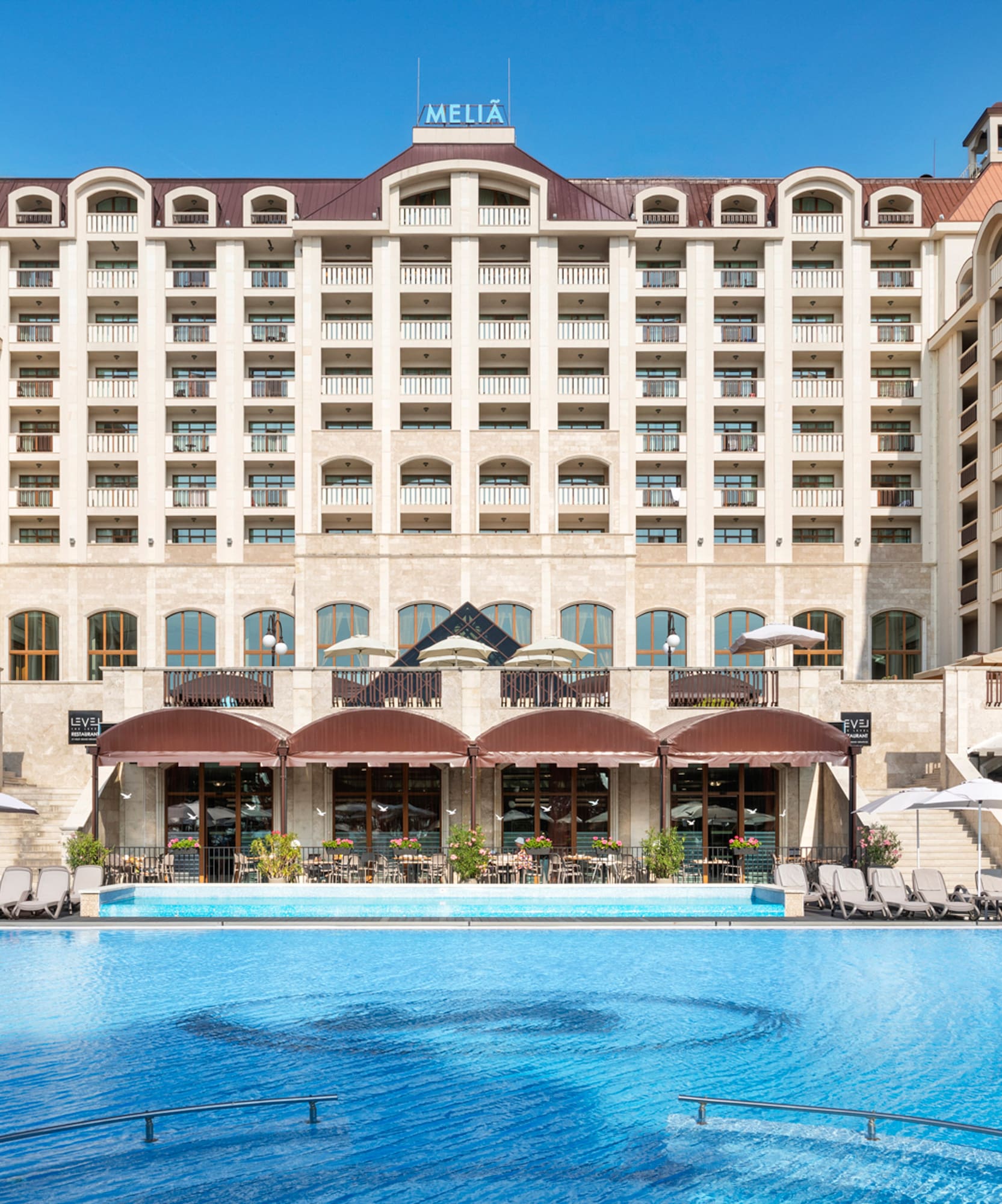 a large building with a pool in front of it