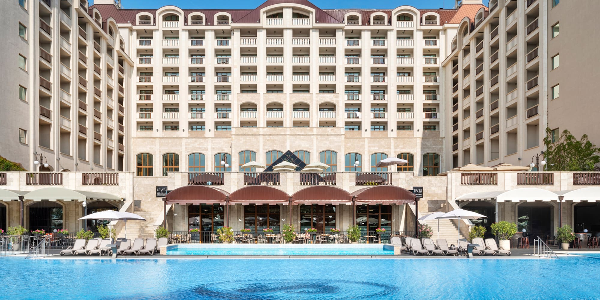 a large building with a pool in front of it