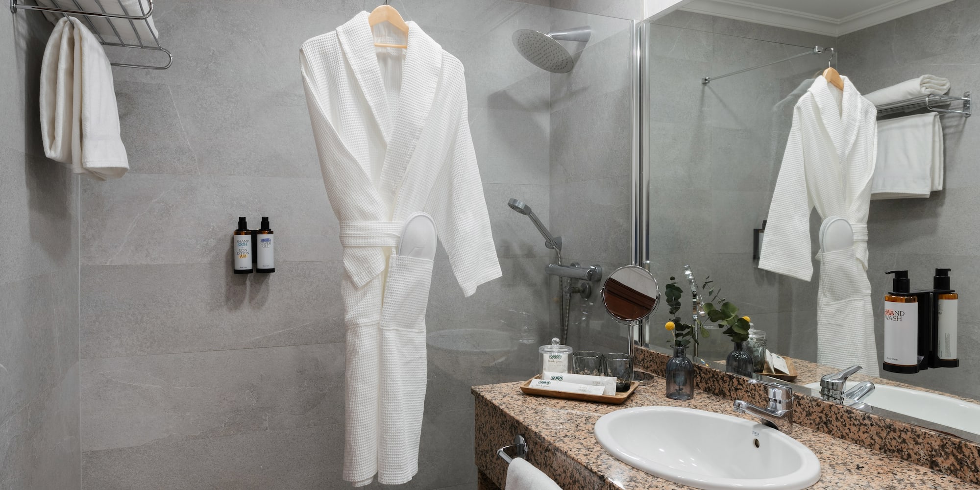 a bathroom with a white robe and sink