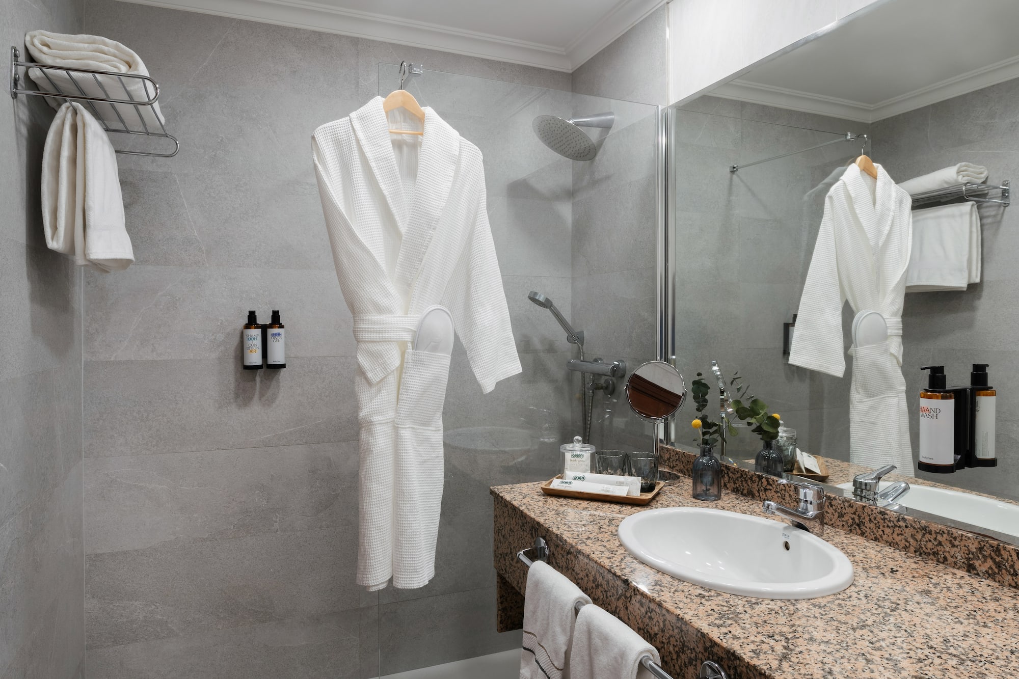 a bathroom with a white robe and sink