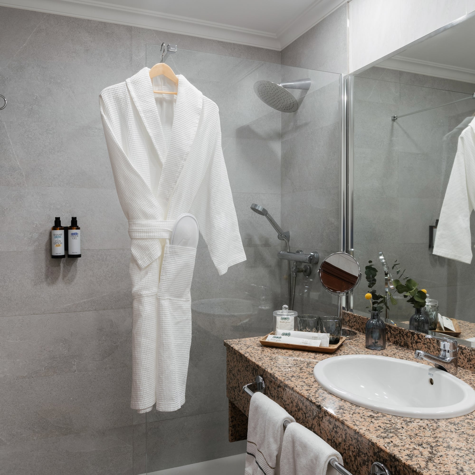 a bathroom with a white robe and sink